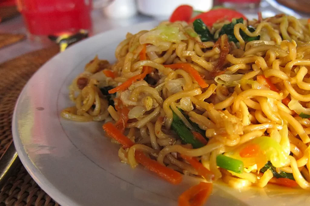 A close-up of mie goreng, a traditional Indonesian noodle dish, on a plate