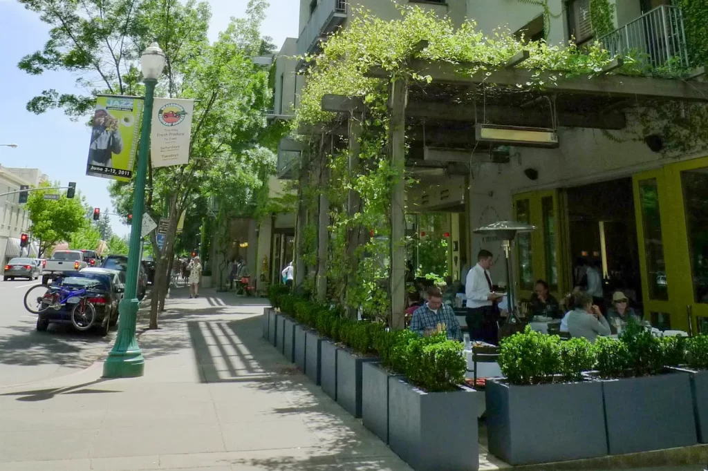 Diners sit on the outdoor shaded patio of Dry Creek Kitchen in Healdsburg, California. Dry Creek consistently ranks among the most popular places of where to eat in Healdsburg.