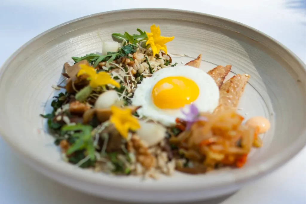 A close-up bowl of rice and eggs served at the Farmhouse Inn Restaurant in Sonoma County, California. The Farmhouse is consistently highlighted of where to eat in Healdsburg.