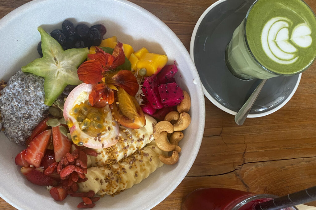 A healthy yogurt bowl and matcha latte at Milk & Madu in Canggu, Bali, Indonesia.
