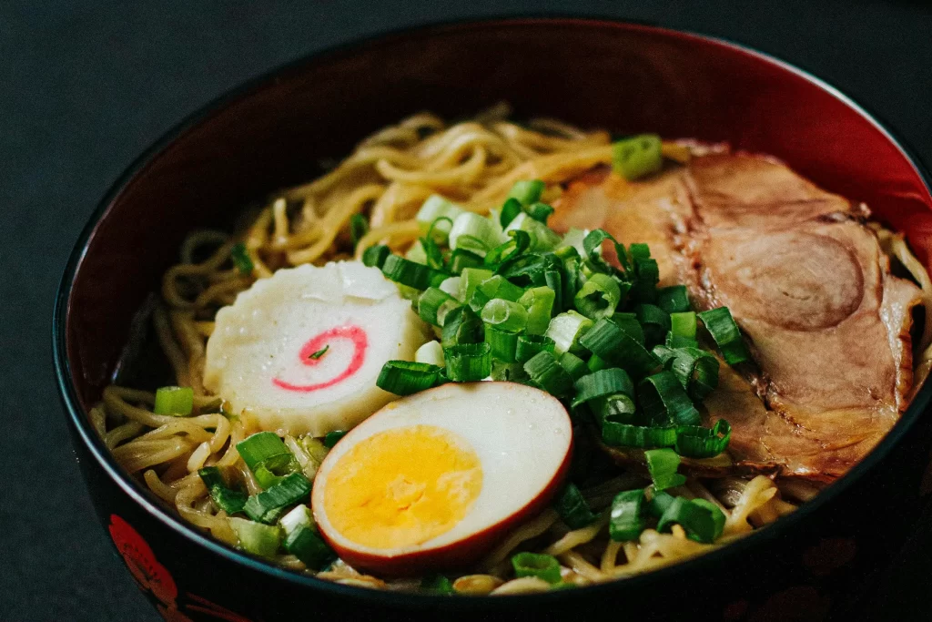 Close up of a bowl of ramen against a dark background