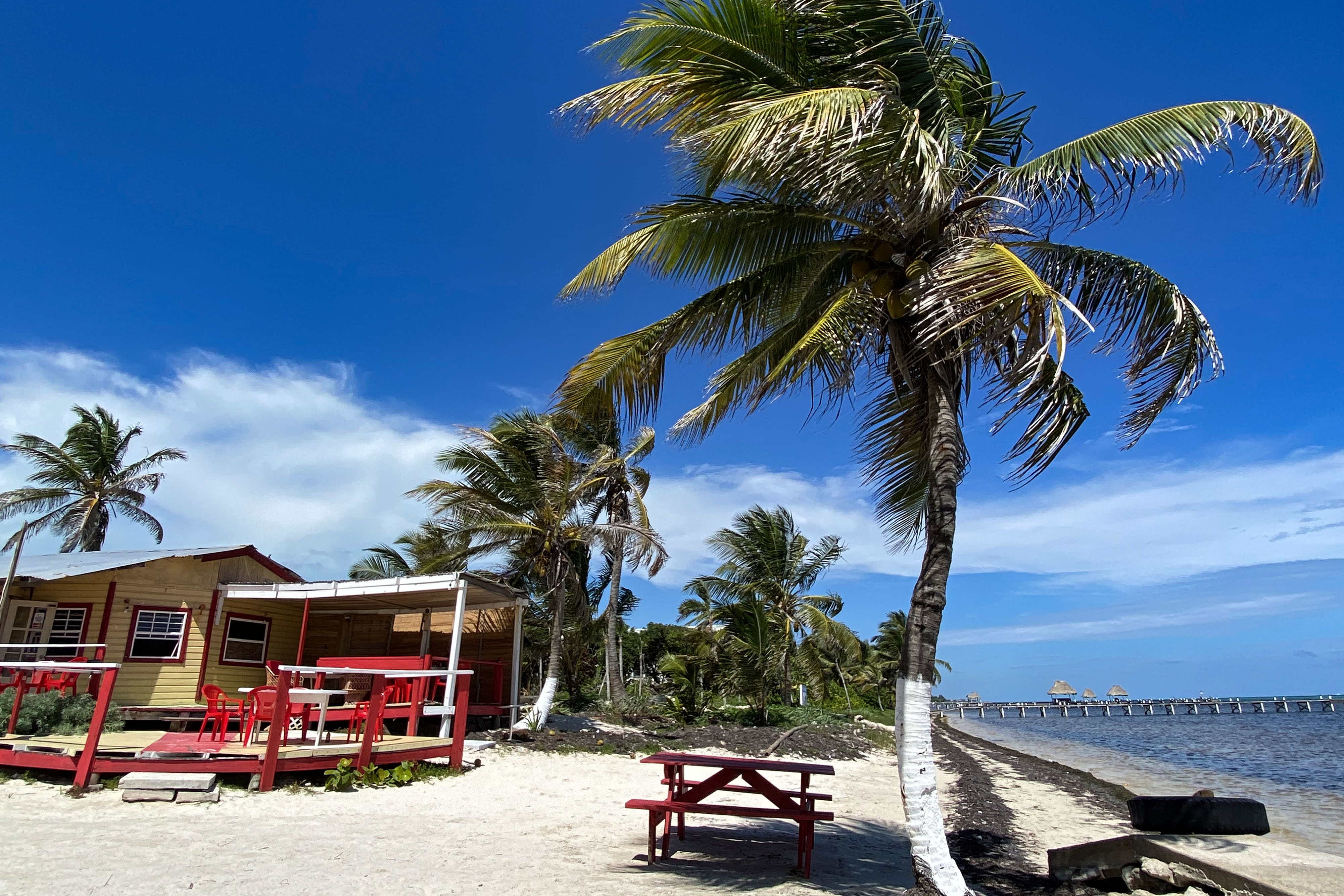 A lunch cafe sits on a deserted stretch of beach on Ambergris Caye, Belize.