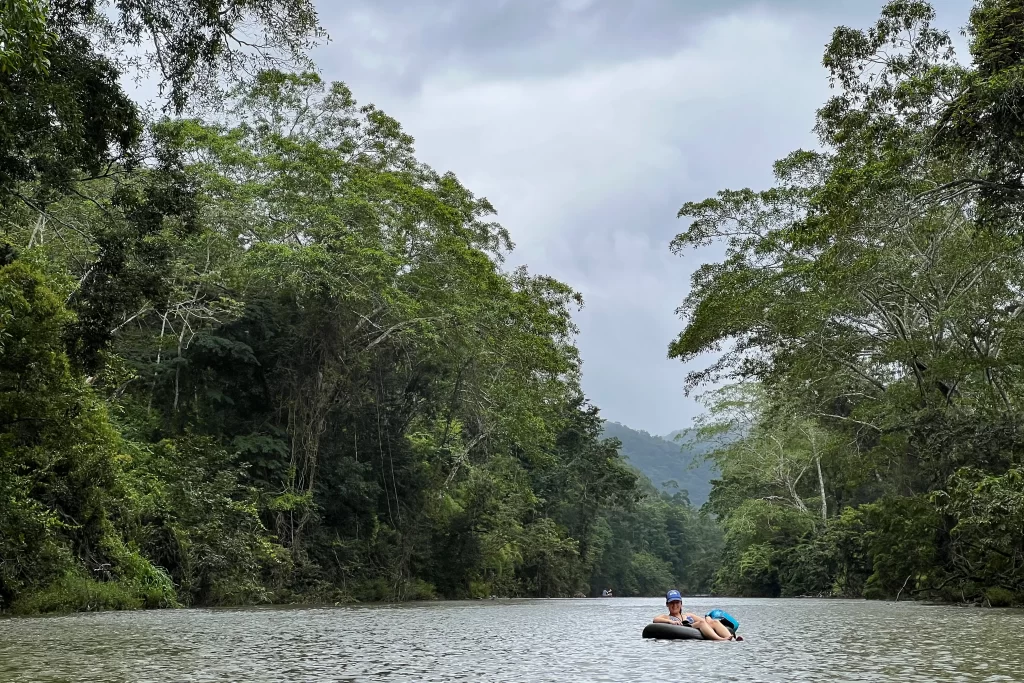 A woman floats in an inner tube down the Macal River in Belize's Cayo District