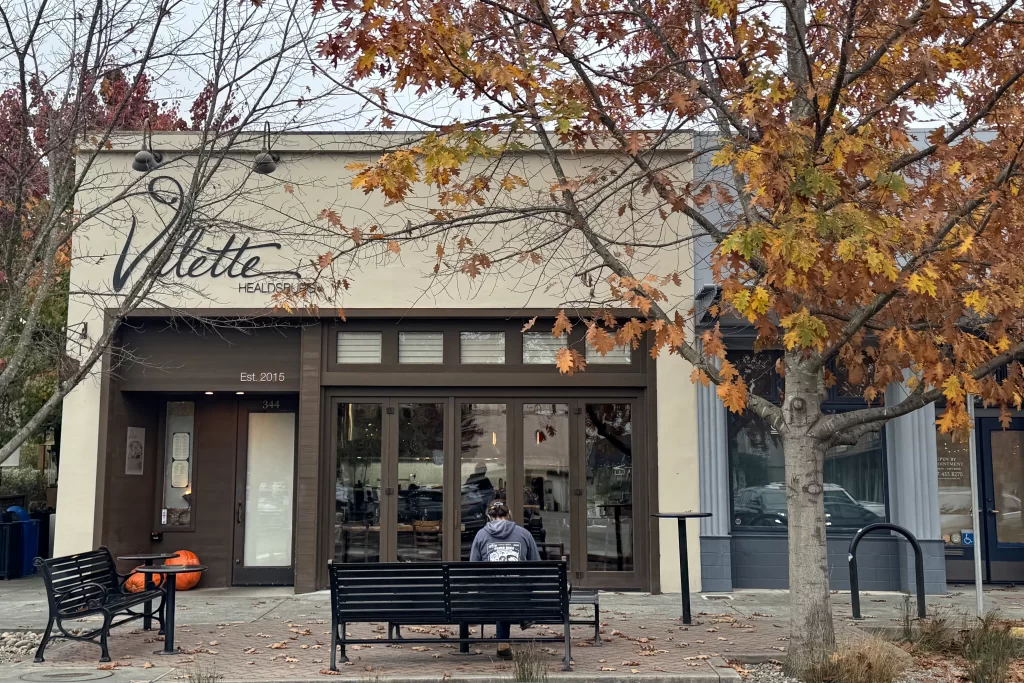 The exterior of Valette, a fine dining restaurant in Healdsburg, California, framed by fall color on the trees outside.