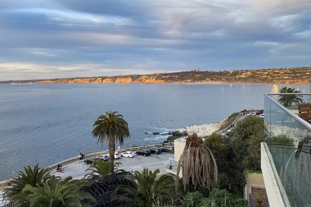 The view from Duke's La Jolla at golden hour, looking out over La Jolla Cove.