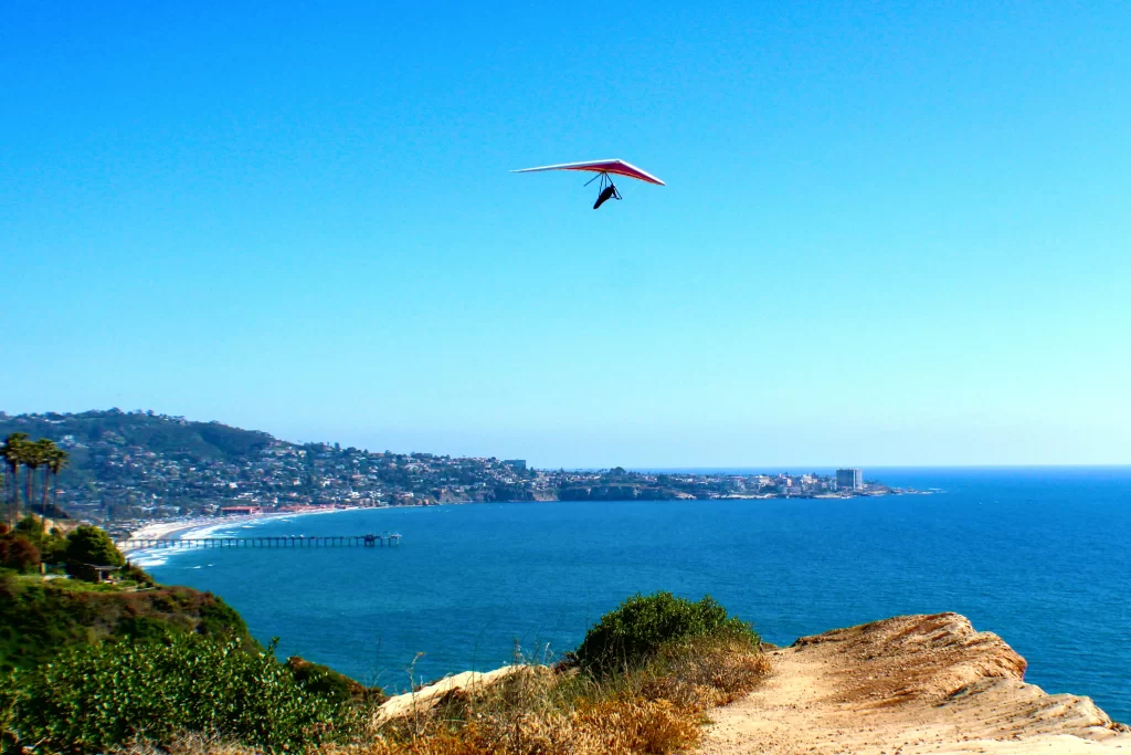 A paraglider soars over La Jolla Cove at the Torrey Pines Gliderport.