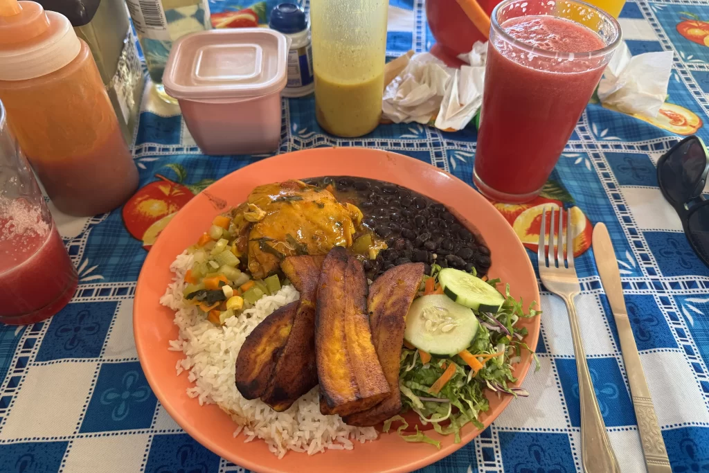 A traditional casado, the national dish of Costa Rica, with rice, beans, fried plantains, and chicken.