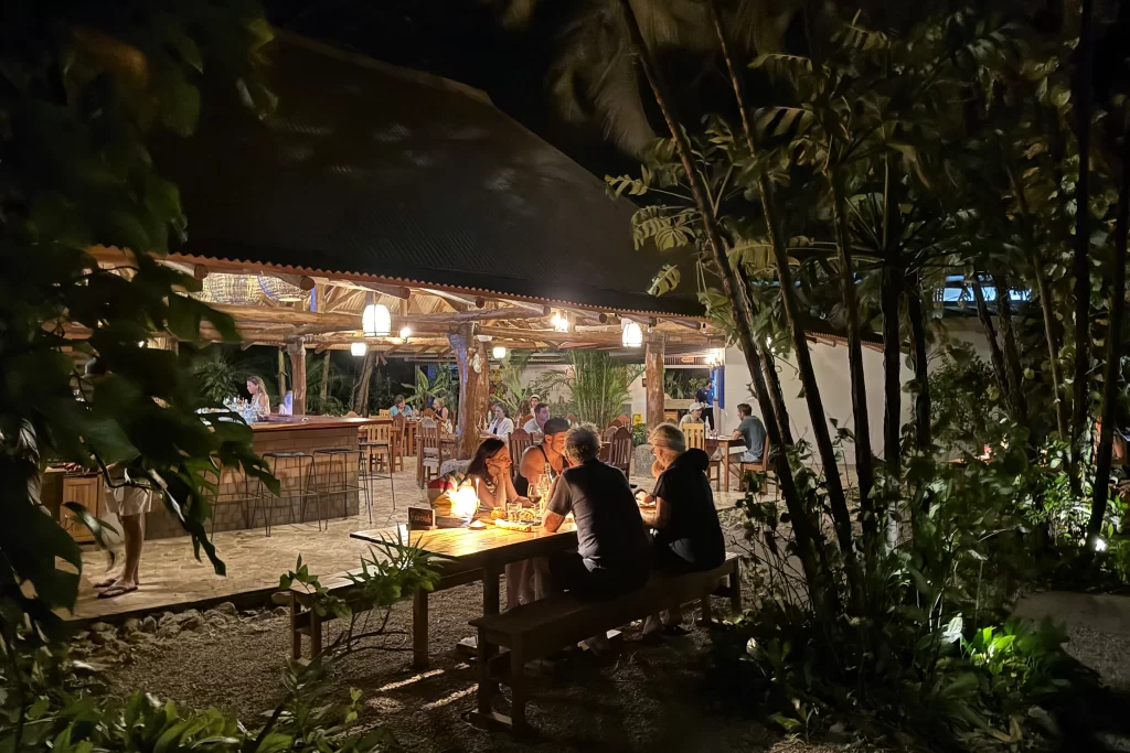 Diners sit along candlelit tables at Al Chile restaurant in Guiones, Costa Rica.