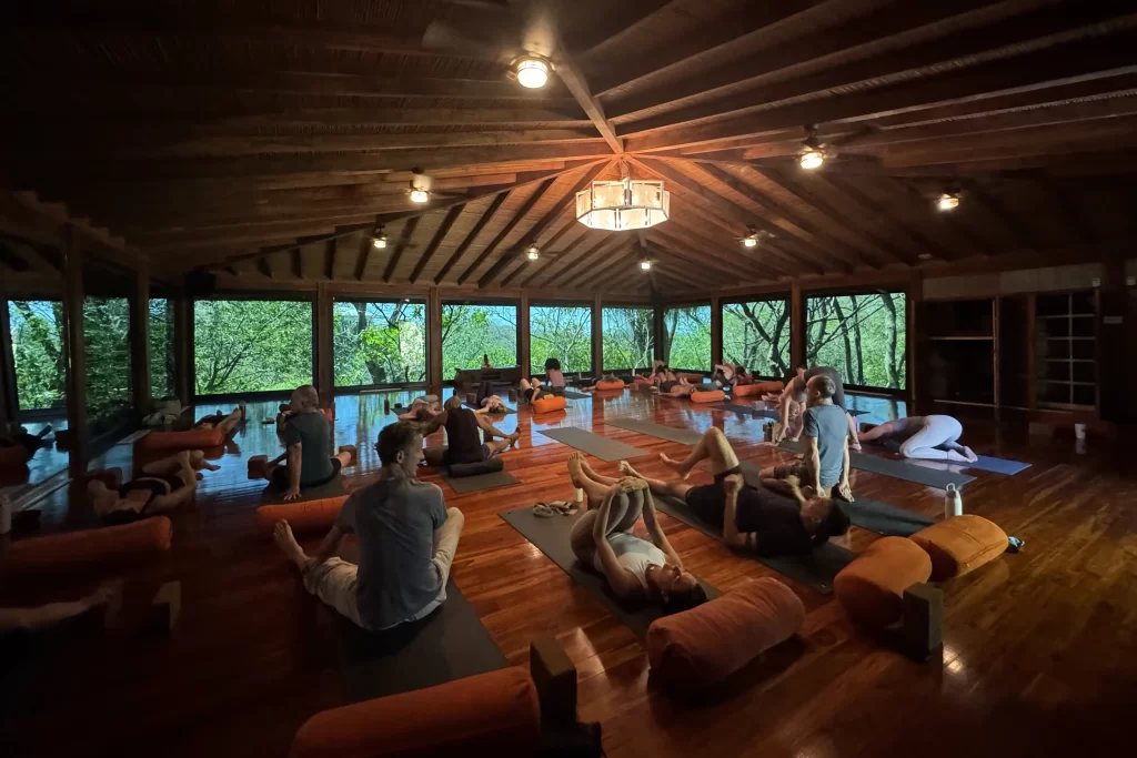 People stretch on yoga mats in a teak-paneled yoga studio at the Bodhi Tree near Nosara, Costa Rica. The Bodhi Tree is one of the most popular Nosara yoga studios.