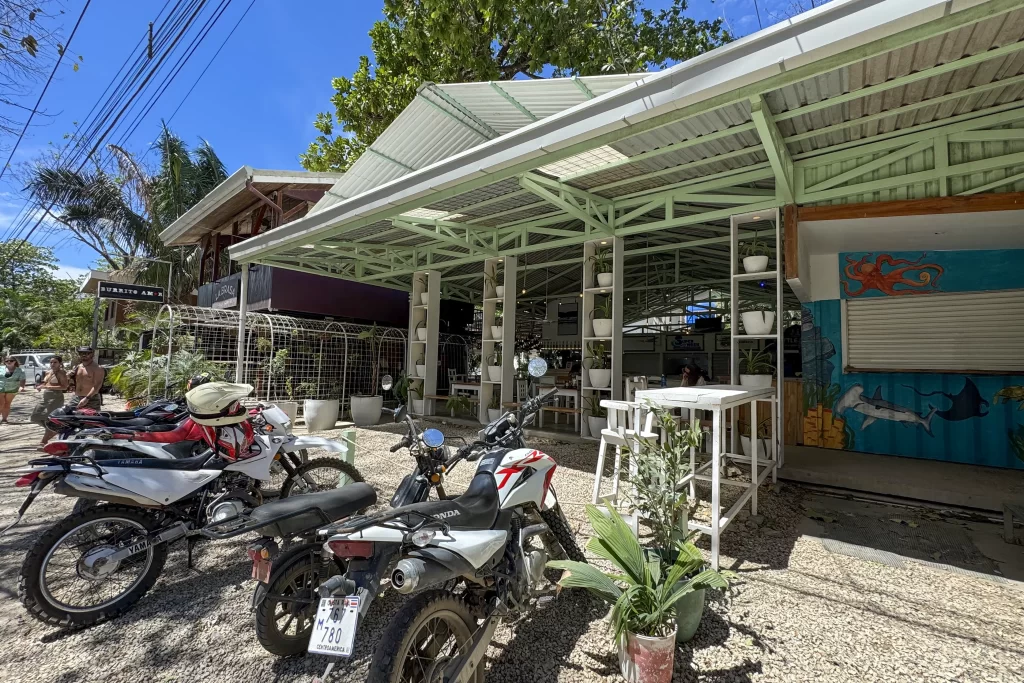 Scooters sit outside Gabi's Place food hall in Nosara, Costa Rica.