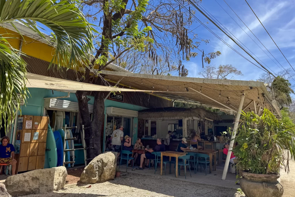 Patrons sit at the casual Howler's Beach Lounge in Playa Guiones, Costa Rica.