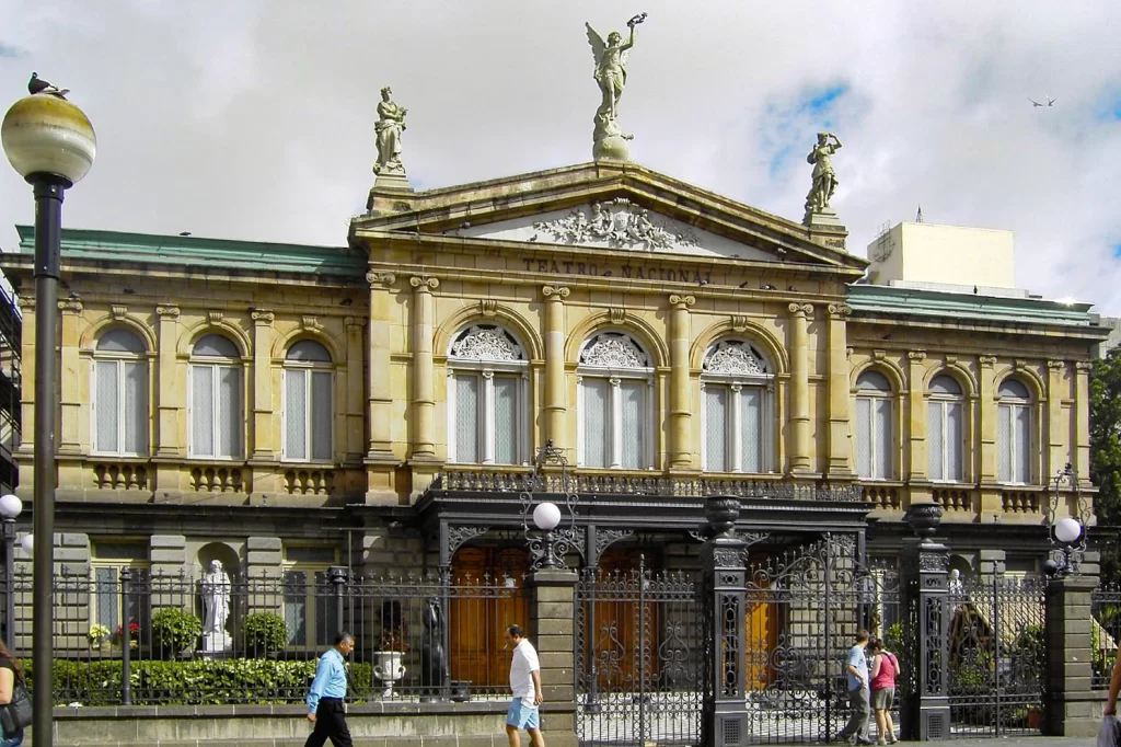 Pedestrians walk past the Teatro Nacional in San Jose, Costa Rica.