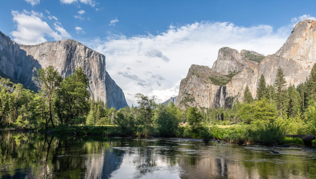 Yosemite National Park's iconic El Capitan and Half Dome are reflected in the waters of the Merced River at Valley View.