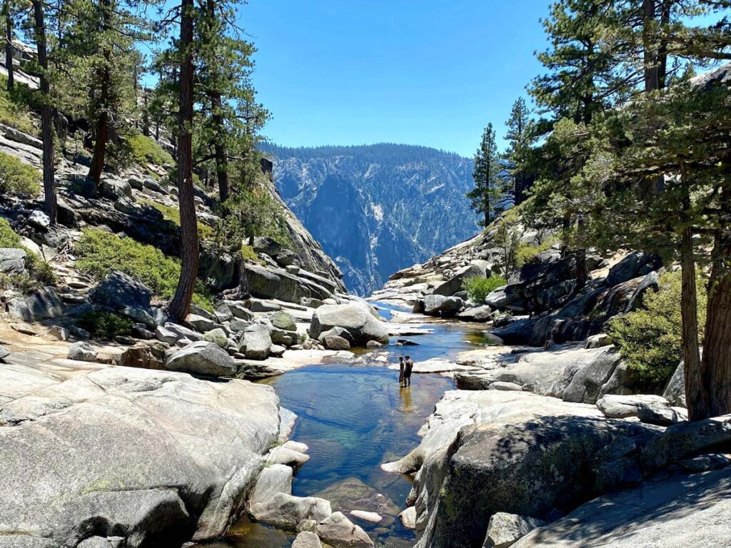 Two hikers cool off in the pools along the Upper Yosemite Falls trail in Yosemite National Park.