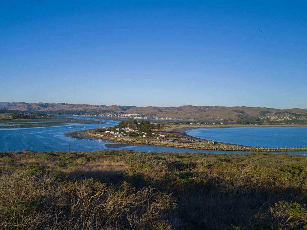 A small landmass separating Bodega Bay, California, as seen from the headlands beyond town.