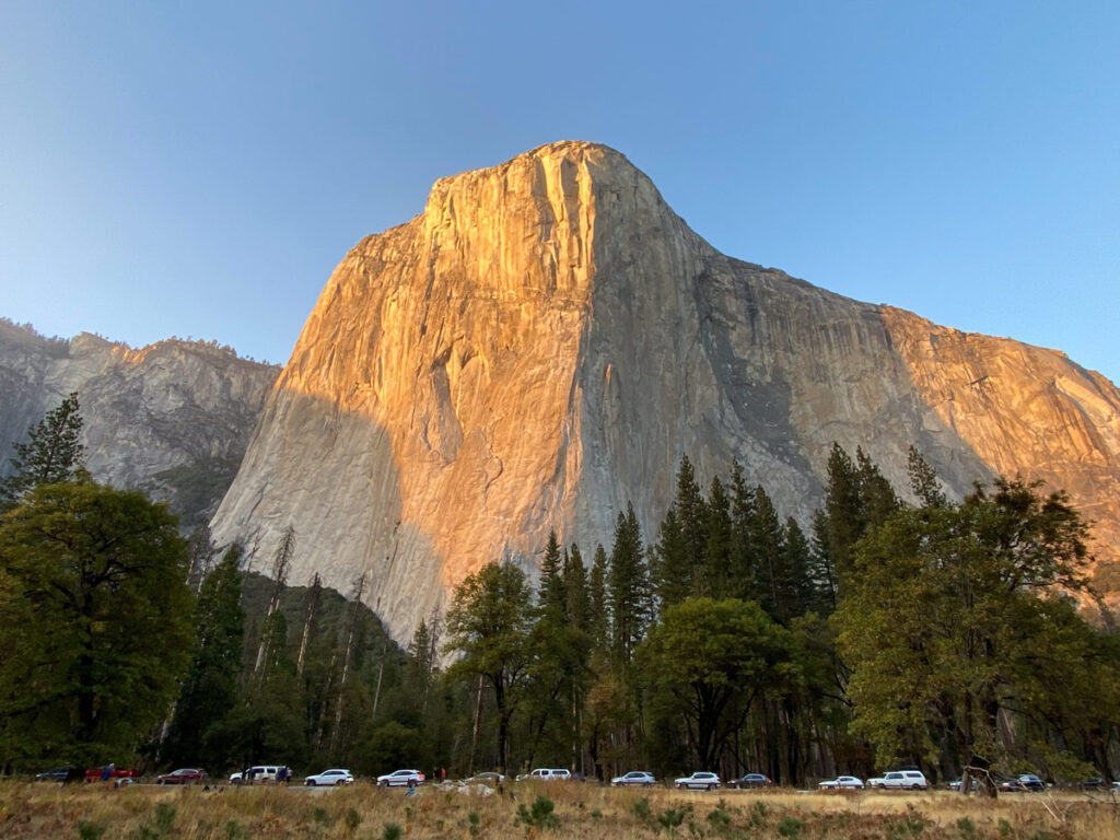 El Capitan is illuminated by alpenglow at sunset in Yosemite National Park.