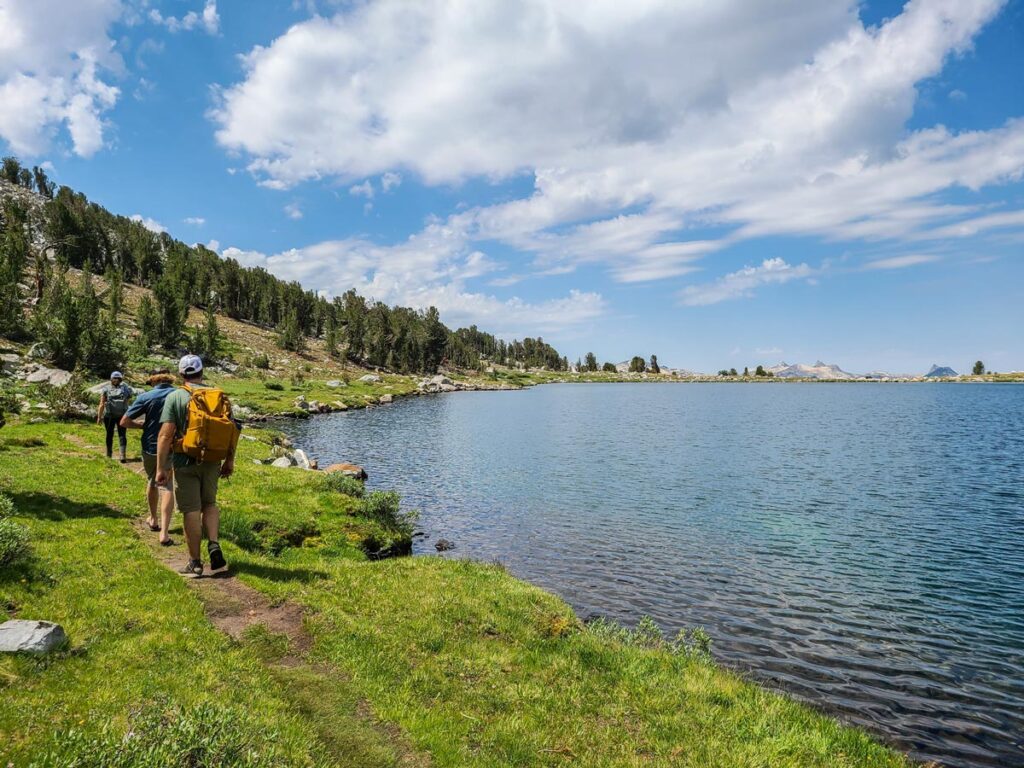 Hikers walk along the shores of Middle Gaylor Lake in Yosemite's high country.