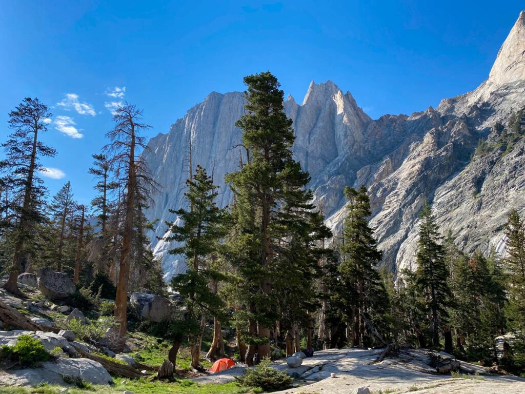 A lone camping tent set back in the trees, along the banks of Hamilton Lake on the High Sierra Trail.