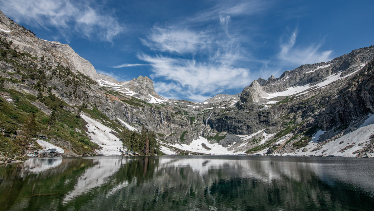 Hamilton Lake on the High Sierra trail in Sequoia National Park, with lingering snow on its shore reflecting on the water.