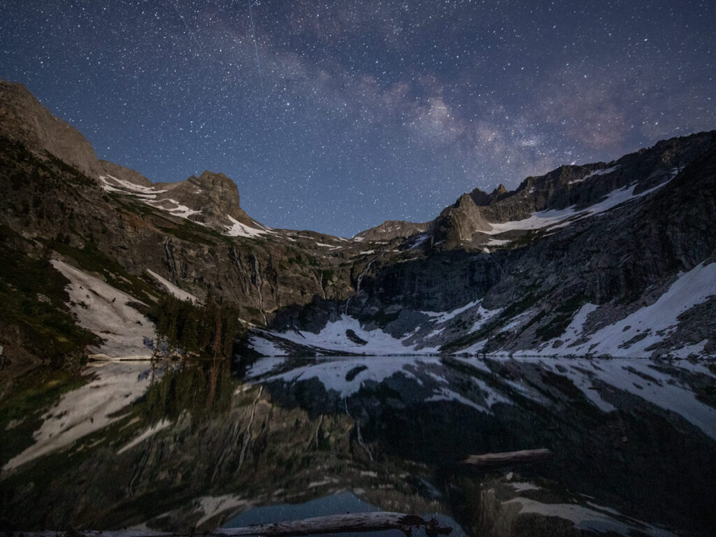 A starry night sky is seen above Hamilton Lake along the High Sierra Trail.