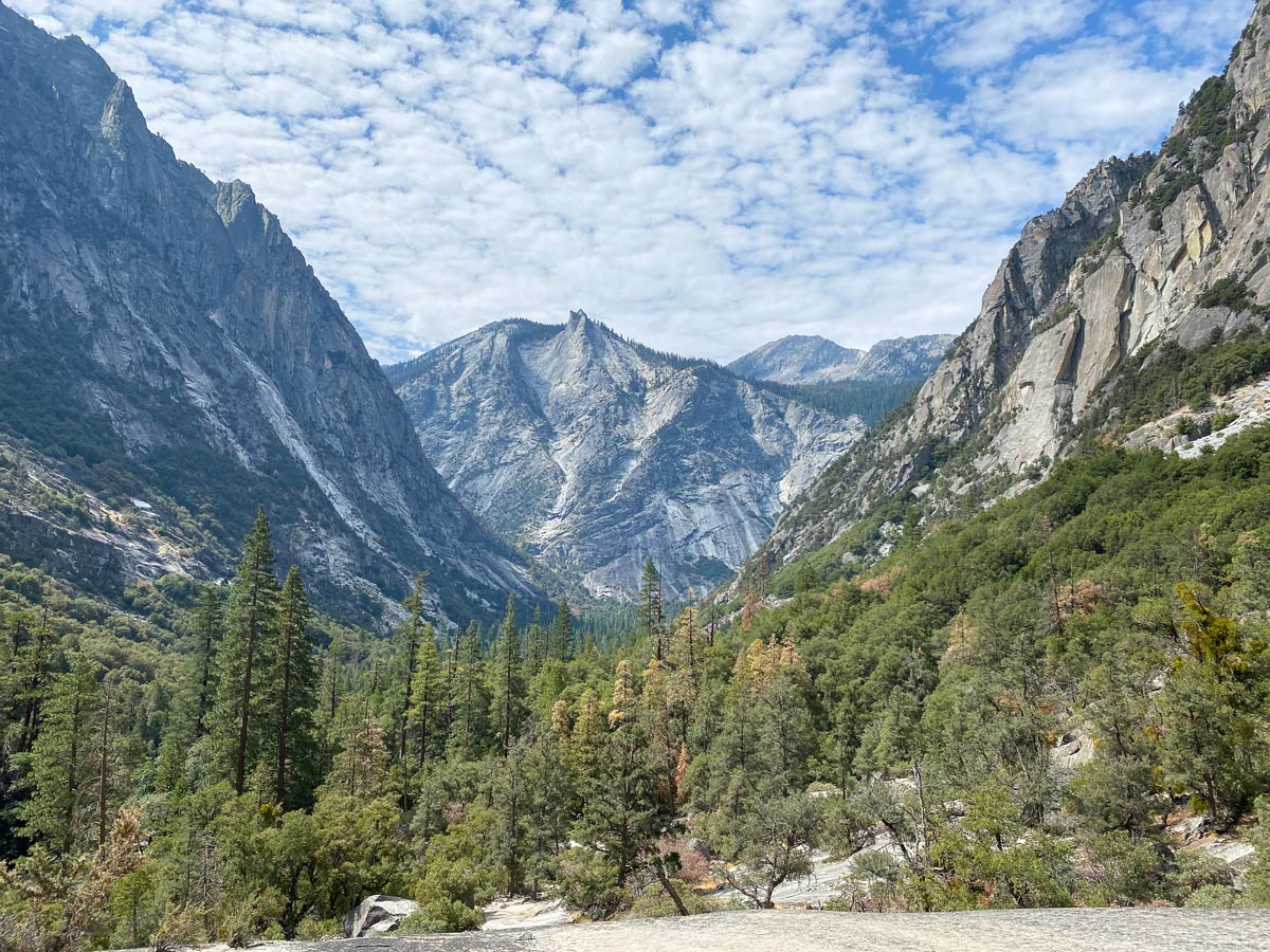 The granite monolith known as the Sphinx, on the Mist Falls Trail in Kings Canyon National Park, is seen from across a jagged valley of conifer trees. With 7 days in Yosemite, Sequoia, and Kings Canyon, you'll see unique sights that tourists with less time often miss. 