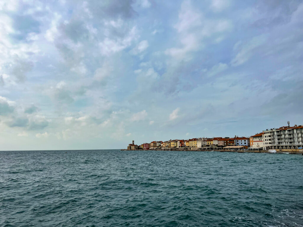 Colorful buildings line the waterfront of Piran, Slovenia, overlooking the Adriatic.