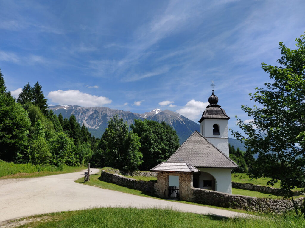 The Church of Saint Catherine, silhouetted against the Julian Alps, sits on the return hike from Vintgar Gorge in Podham, Slovenia.