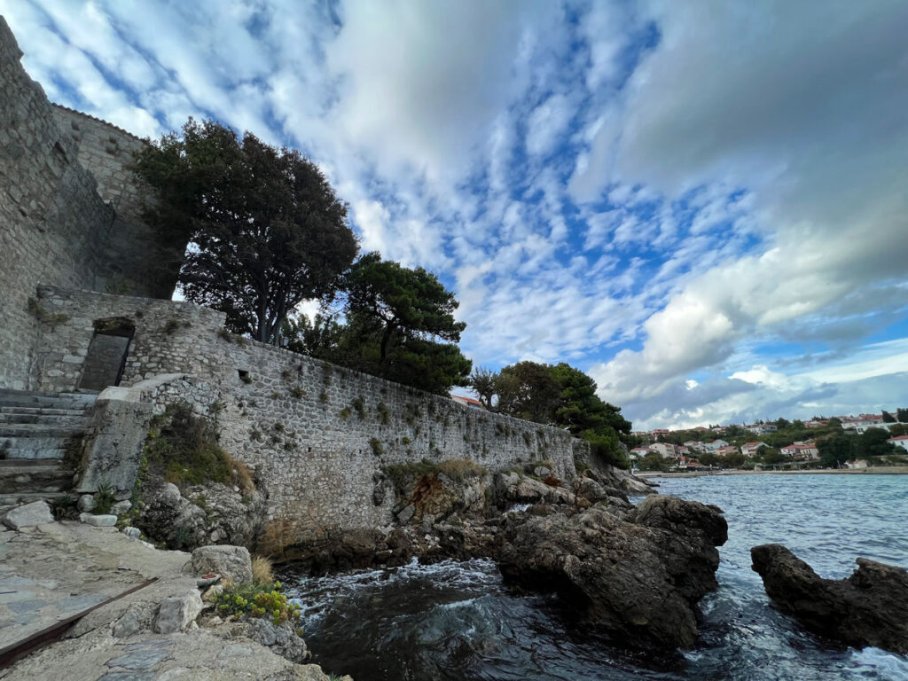 The walled fortress of Frankopan Castle rises above the Adriatic Sea in Krk, Croatia.