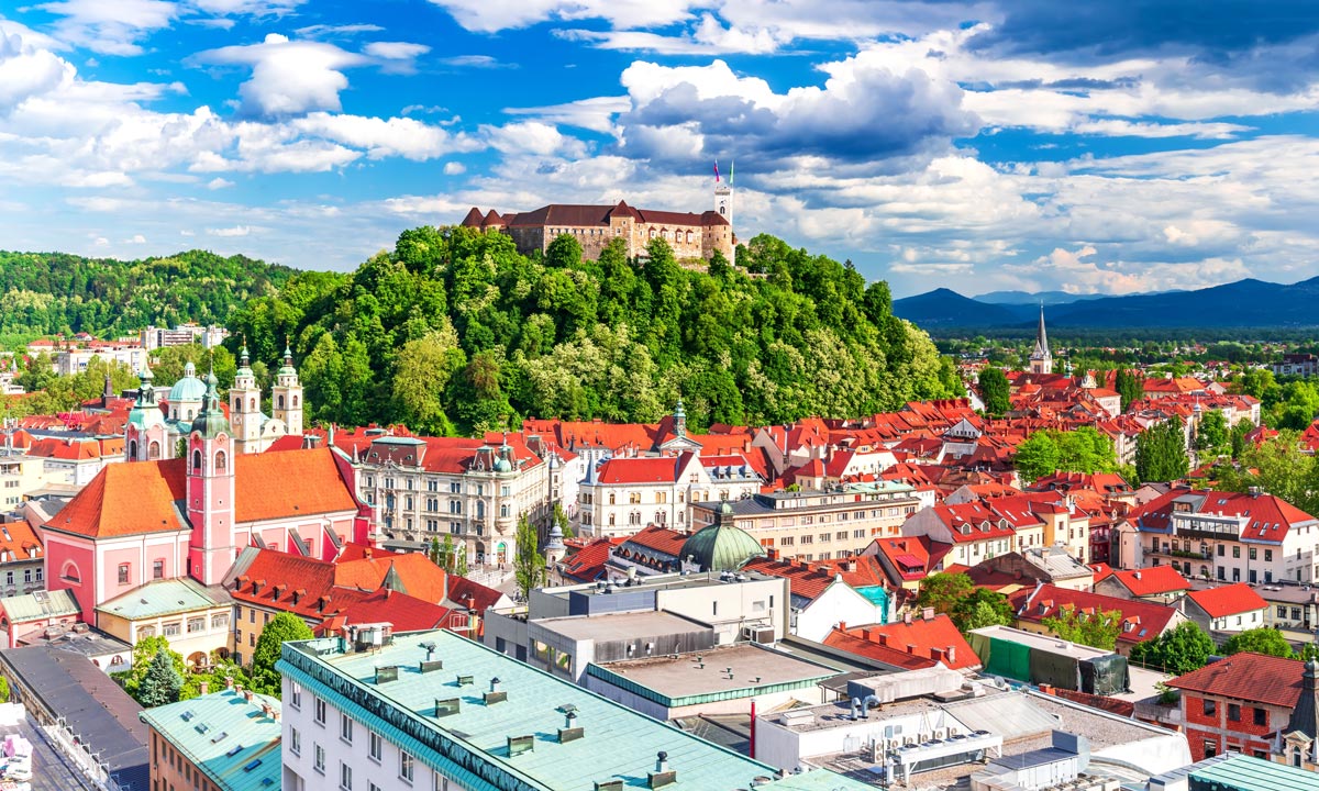 Ljubljana Castle rises on a hill above the rooftops of the old town in Slovenia's capital city.