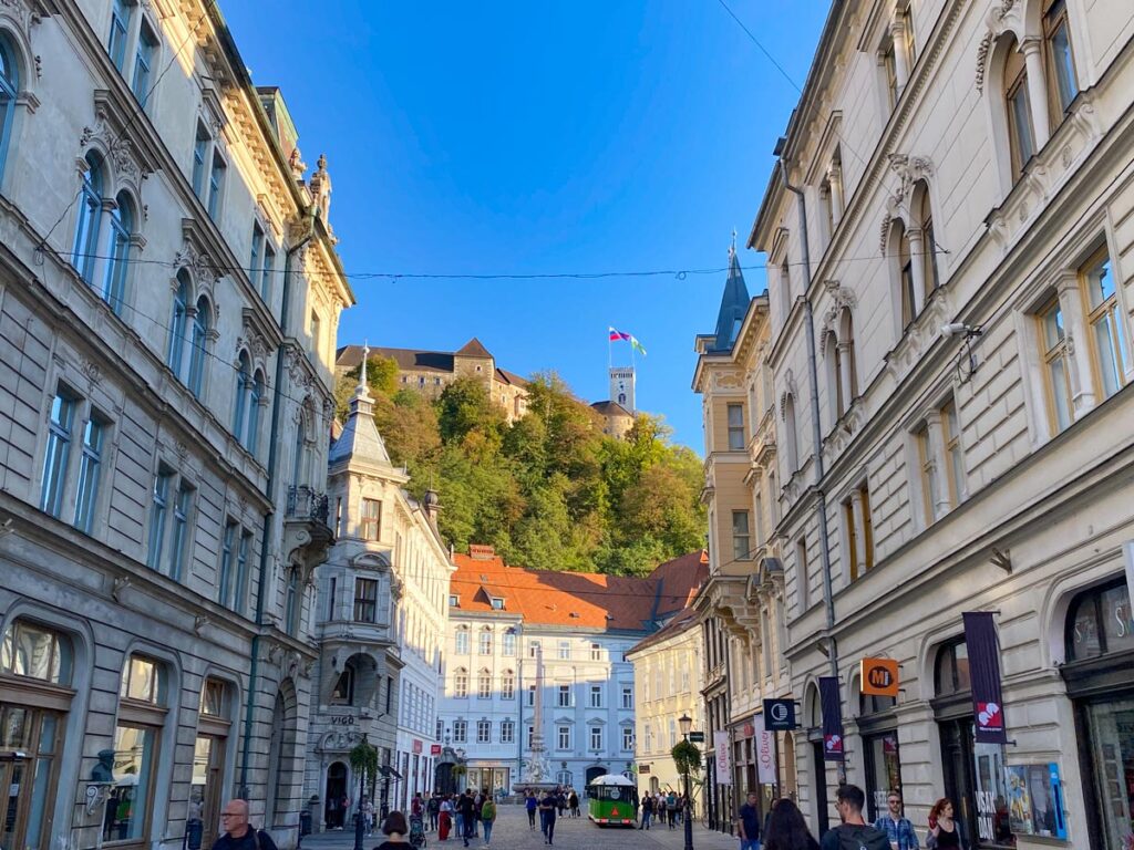 A street view of the old town in Ljubljana, Slovenia, looking up towards Ljubljana Castle.