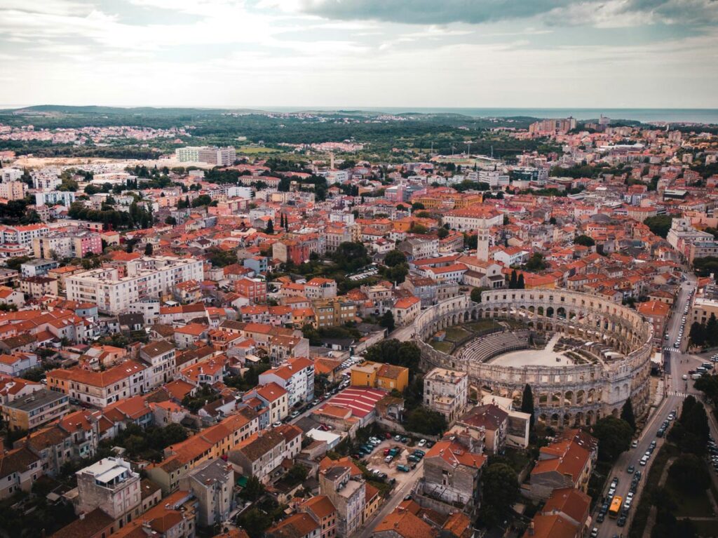 The old town of Pula, Croatia, as seen from above with the Roman Amphitheatre prominent in the foreground.