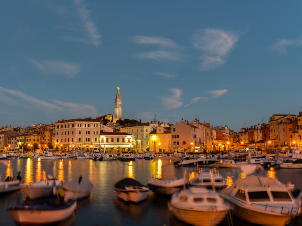 Small boats dot the marina at twilight in Rovinj, Croatia.