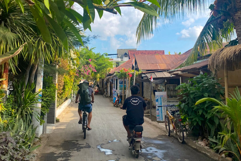 A tourist bikes the back roads of Gili Air in Indonesia.