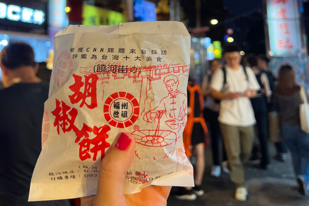 A wrapped Fuzhou pepper bun is held in Taipei's Raohe Night Market.