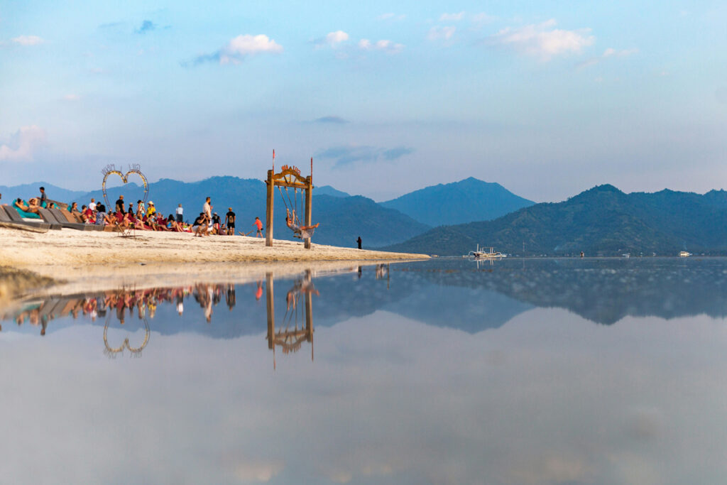 A tourist swings on a beach swing on Indonesia's Gili Air island.