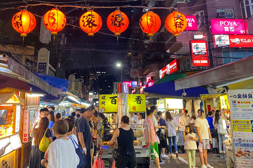 Pedestrians stroll the crowded streets of Linjiang Night Market in Taipei, Taiwan.