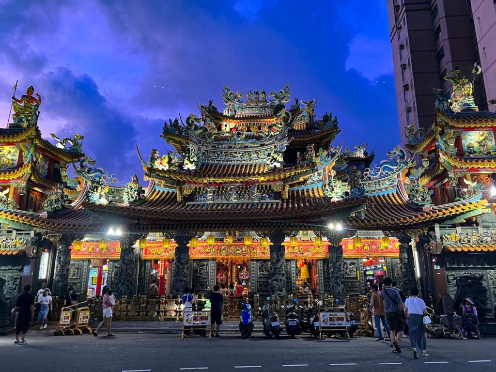 Songshan Ciyou Temple in Taipei, Taiwan is illuminated at dusk.