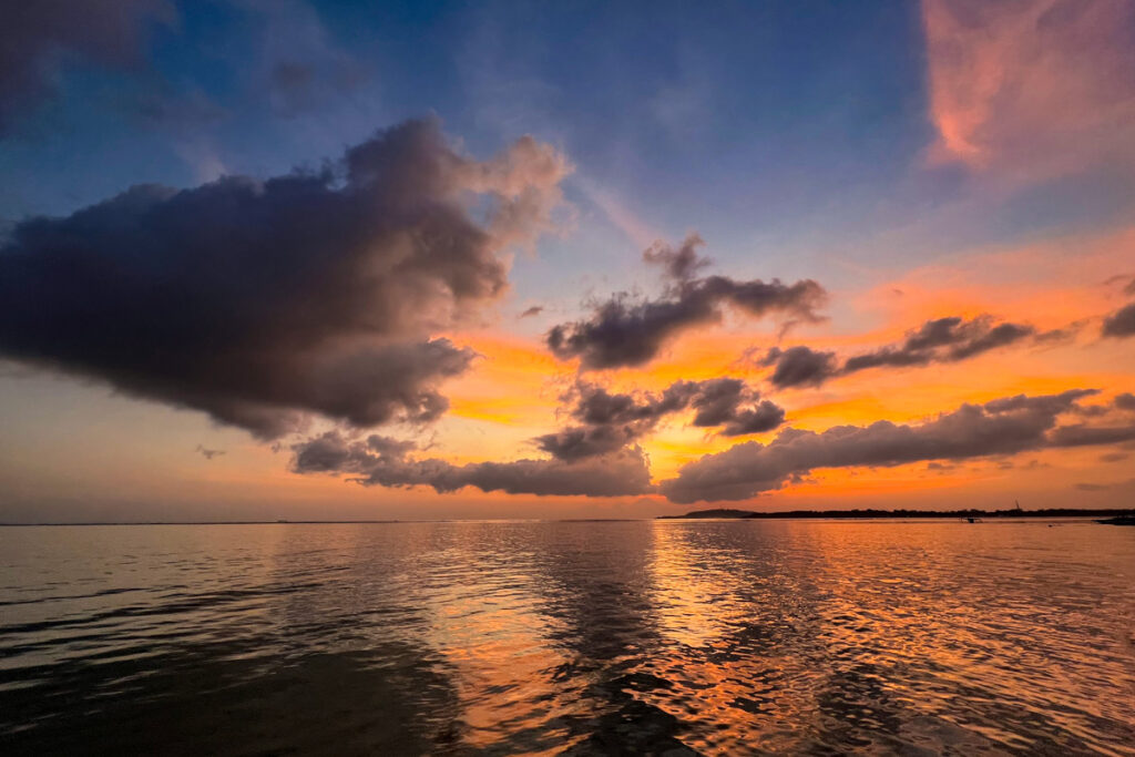 A fiery sunset on Gili Air, with Mount Abung on Bali visible in the distance.