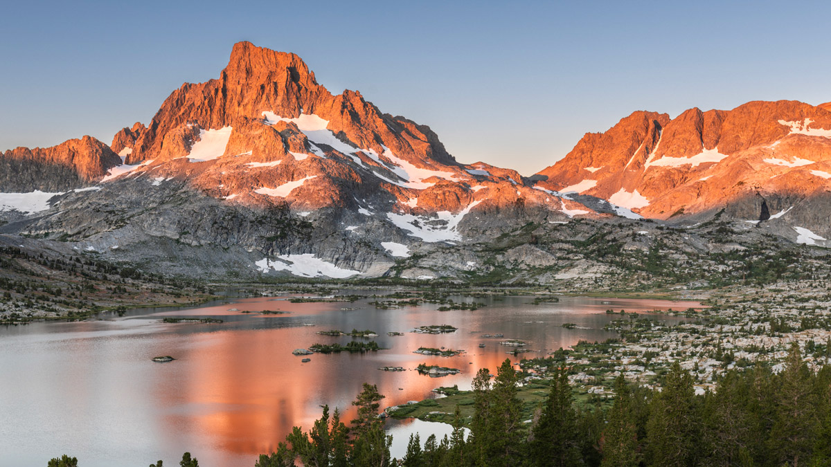 Thousand Island Lake in the eastern Sierra is seen at sunrise, with alpenglow on Mount Banner reflected on the lake.