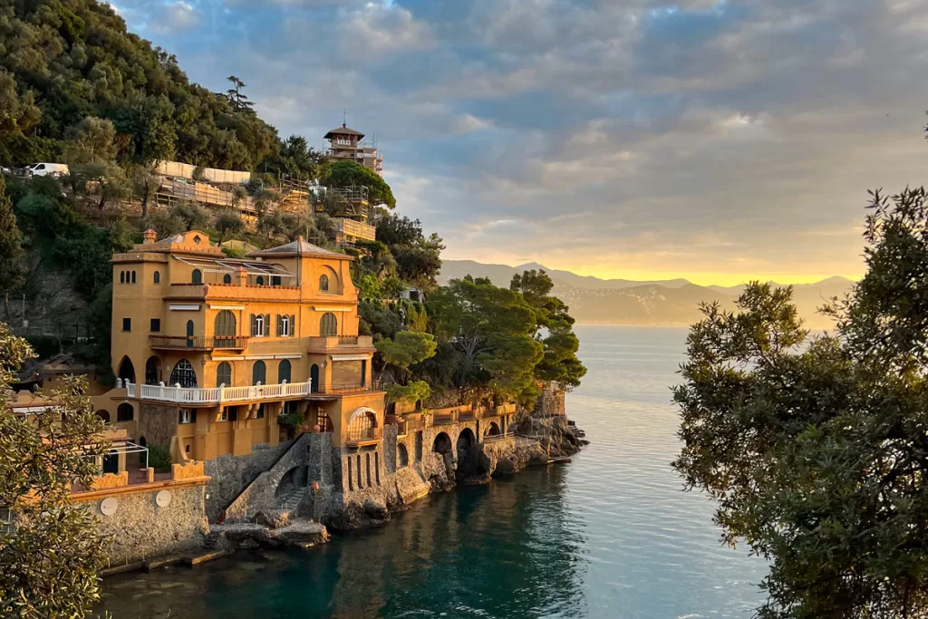 Sunrise illuminates the mustard-yellow Villa Valdermari Mondadori in dreamy hues outside of Portofino, Italy.