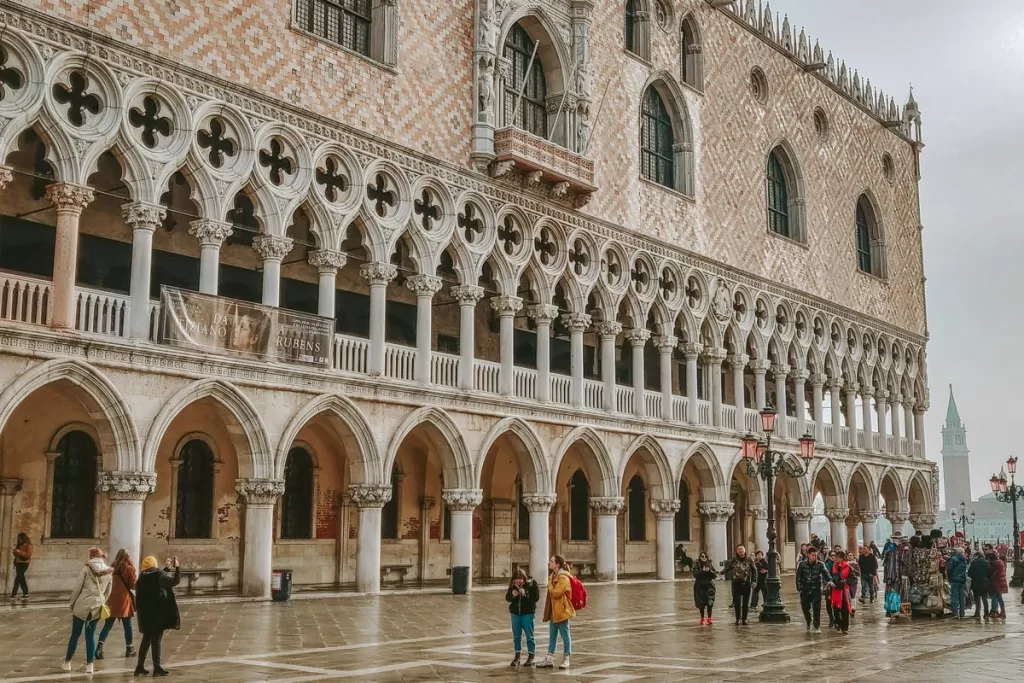 Tourists stand outside the Doge's Palace in Venice Italy.