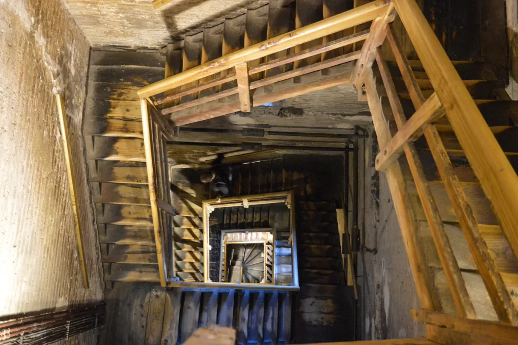 The interior wooden stairs of the medieval Asinelli Tower in Bologna, Italy.