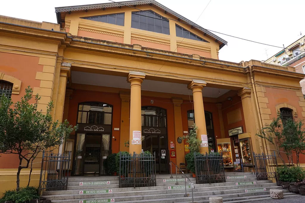 The honey-colored entrance of Mercato delle Erbe, one of Bologna's famous food markets.