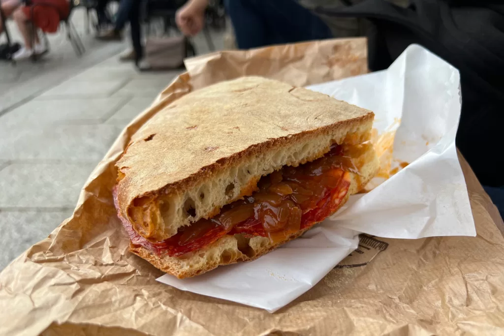 Close-up of a traditional panino (sandwich), with crusty bread and local prosciutto, in Bologna, Italy.