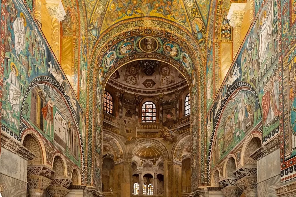 The gilded interior of Basilica di San Vitale, covered in brightly-colored Byzantine mosaics, in Ravenna, Italy.