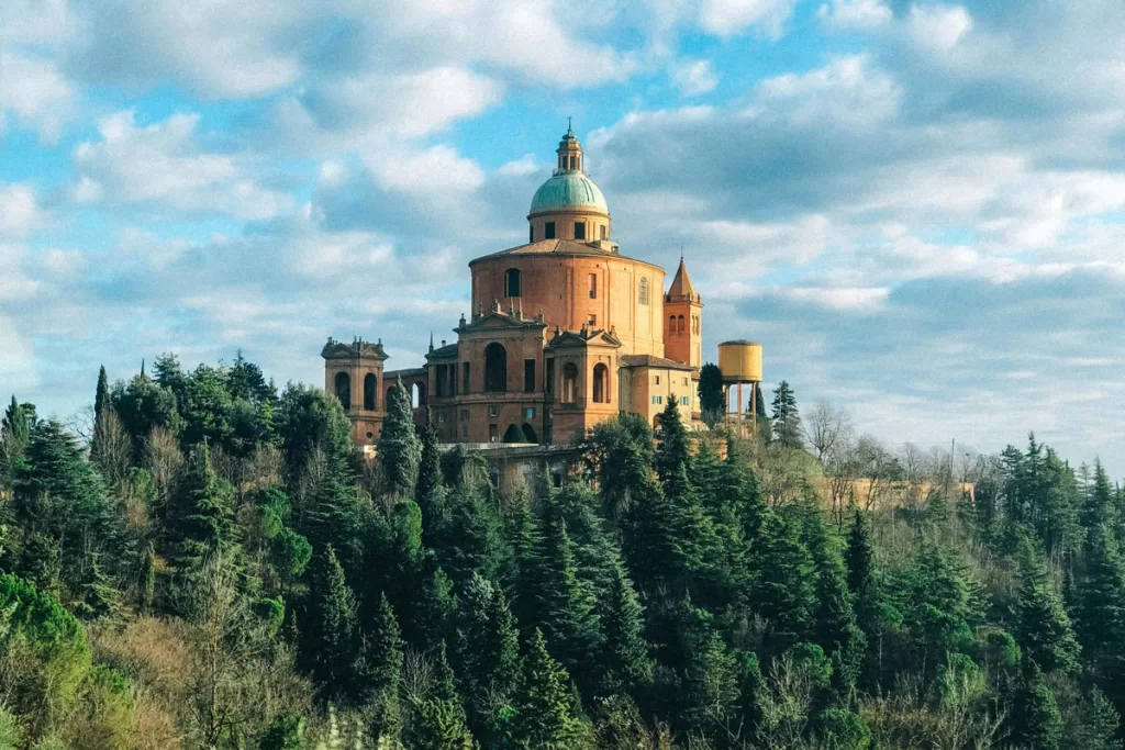 The Sanctuary di San Luca rises above a forested hillside near Bologna, Italy.