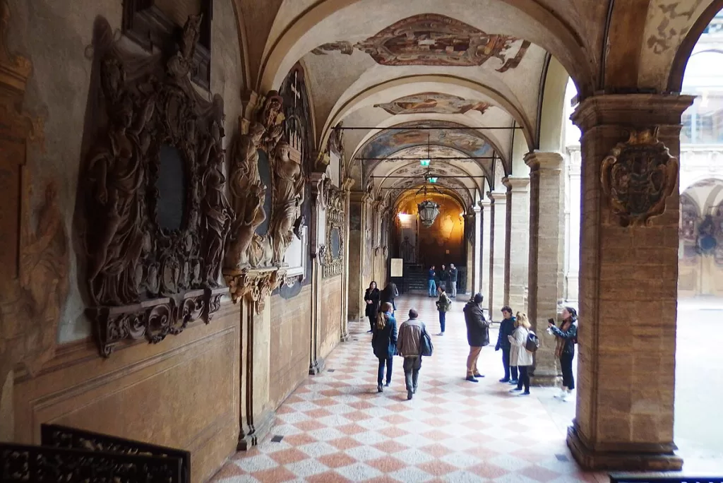 Students walk under ornate porticoes at the University of Bologna, the oldest continually-operating university in the world.