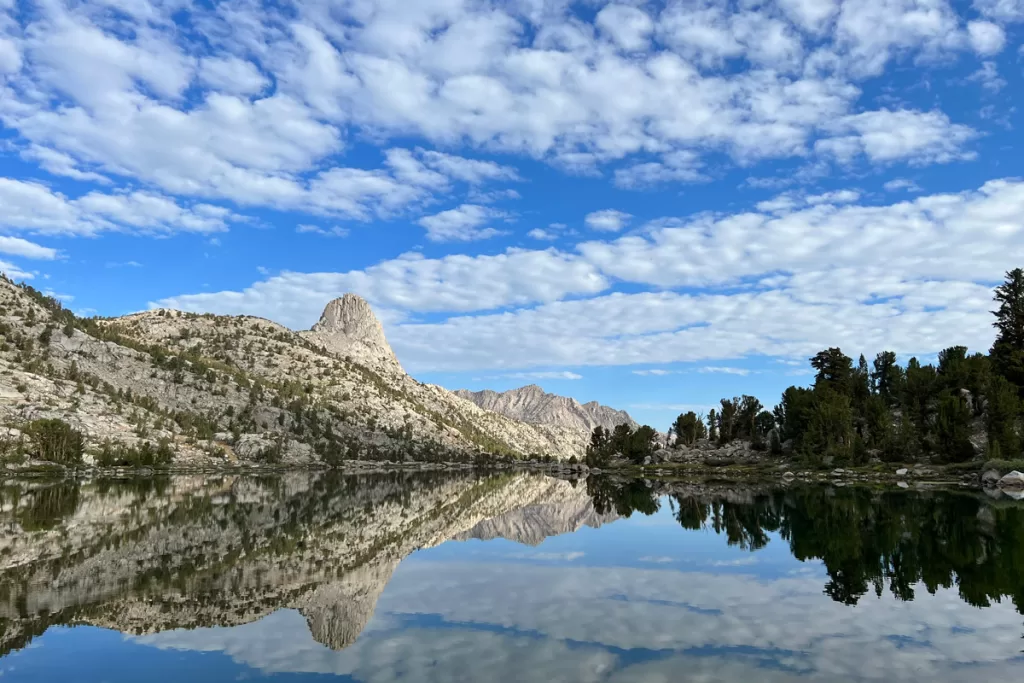 Fin Dome is reflected in the still waters of Dollar Lake along the Rae Lakes Loop in Kings Canyon National Park.