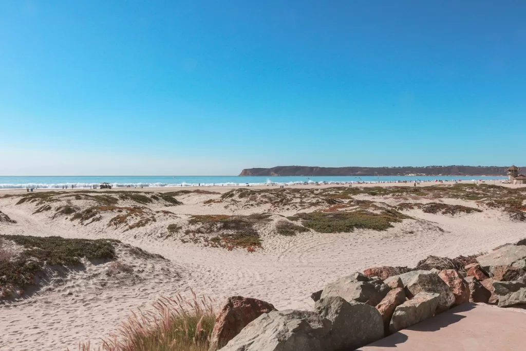 Sand dunes look out over the Pacific Ocean and Point Loma peninsula in Coronado, California. The beach is consistently rated among the nation's best, and is one of the most popular things to do in Coronado.