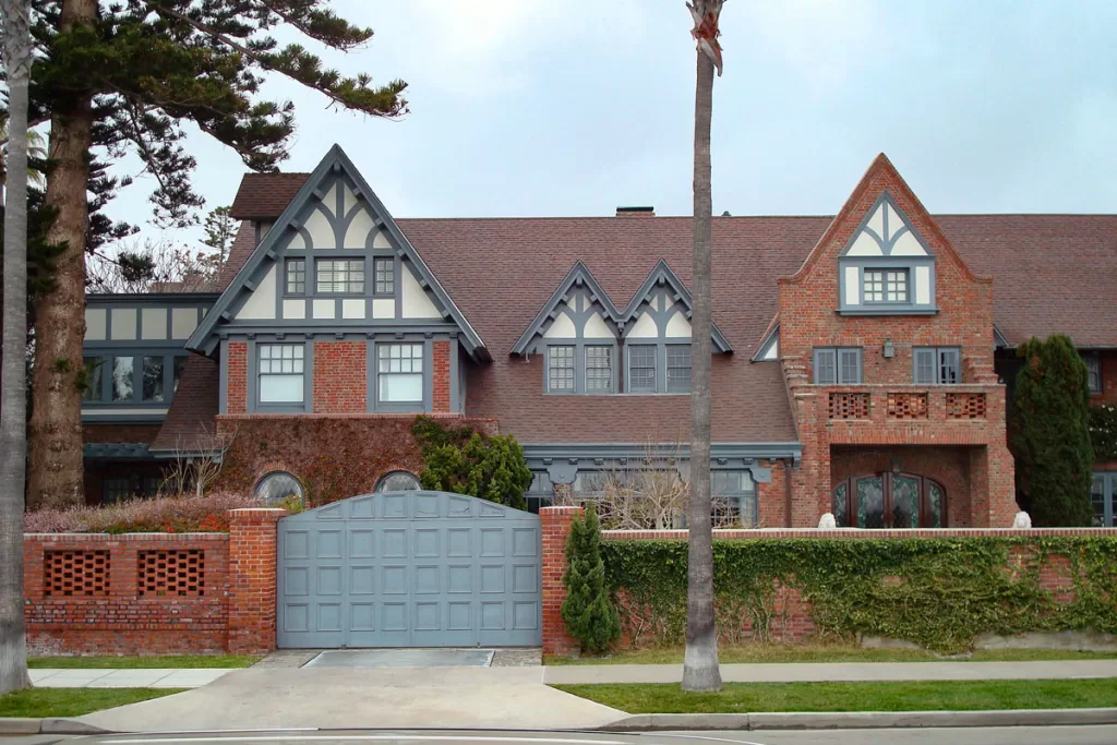 The sprawling red brick facade of Crown Manor, a historic home in the English style in Coronado, California.